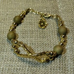 Gold beaded bracelet with clasp...unique stones.